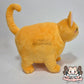 Orange fat cat in a sweater